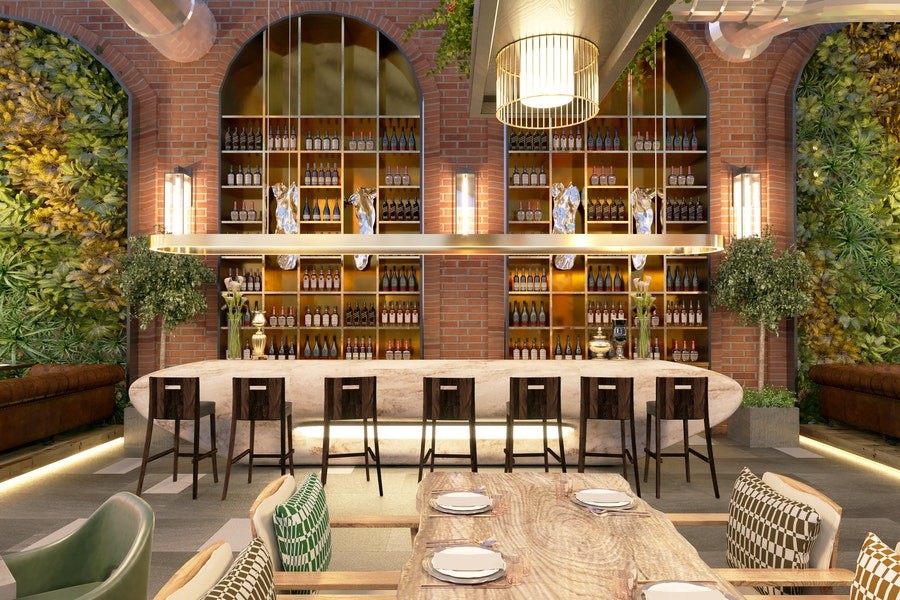 A hotel bar with interior brick, plants, and bright, warm lighting.
