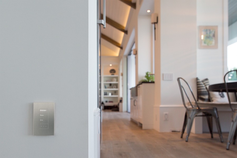 Lutron Palladiom keypad in a white, modern house with a wood beam ceiling.
