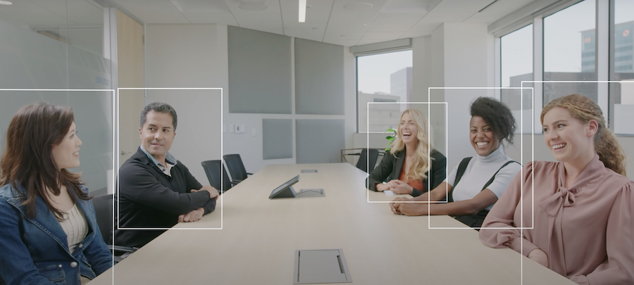 People sitting around a conference room table. White boxes surround each person, capturing them in the video conferencing system.
