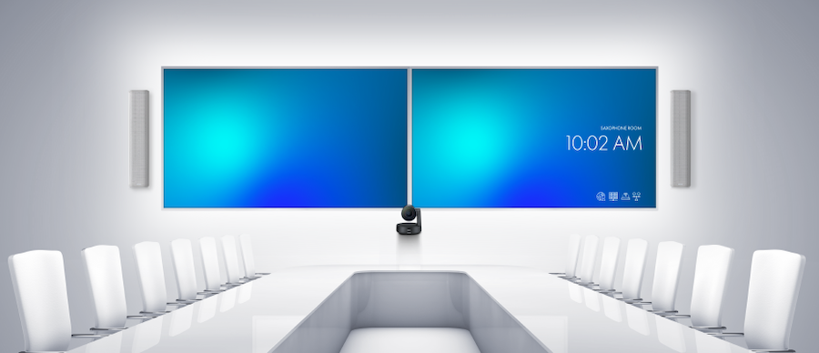 Conference room audio video in a bright white room with two large displays.