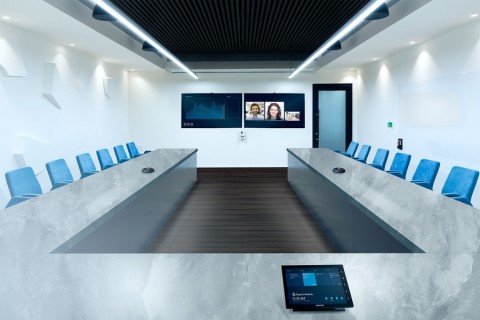 A conference room with a display and in-table control.