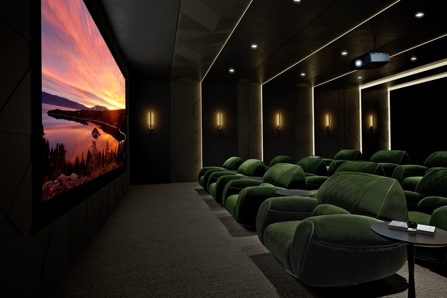 A luxury home theater with green velvet seats and LED light strops on the walls.