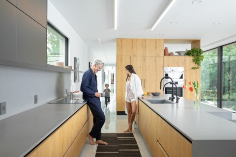 A family in a bright, modern home with a Savant smart system.