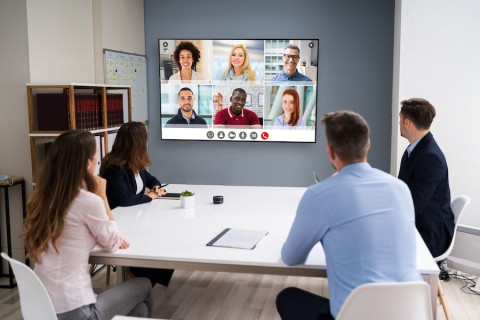 A huddle room with a Zoom Room video conferencing setup.
