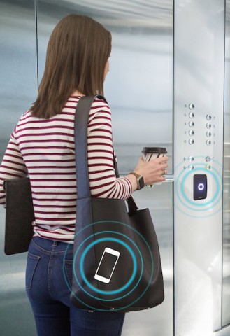 Person scanning an ID card on an access control system.