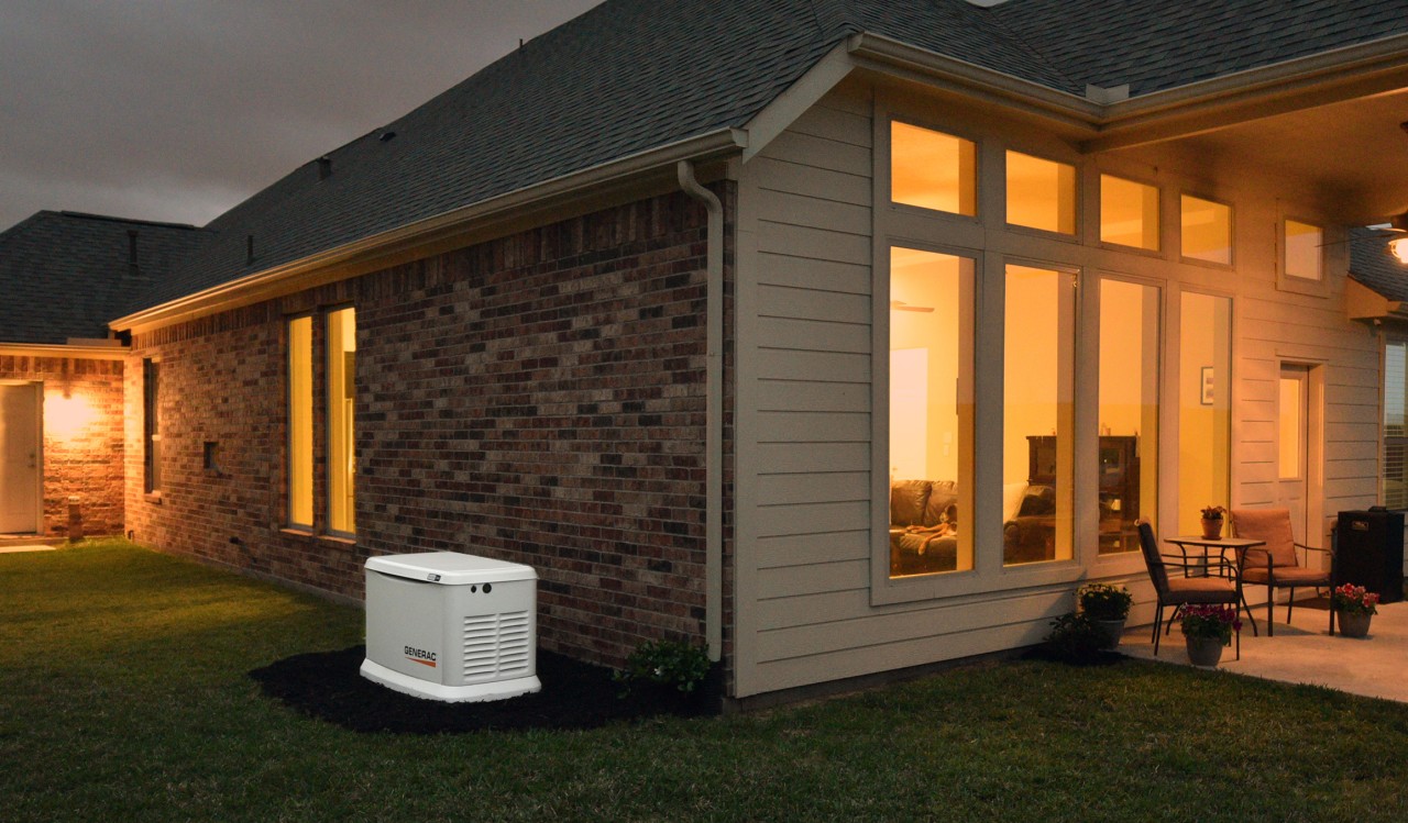 A house at night powered by a Generac home generator. 