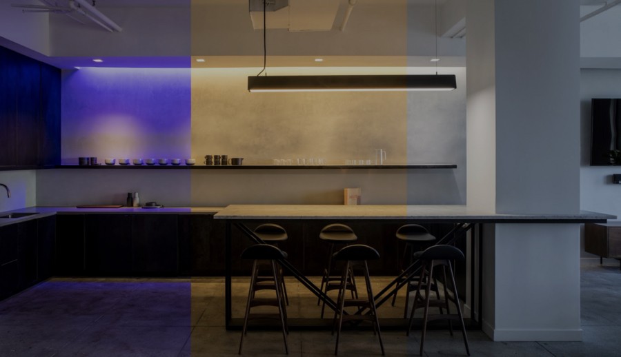 Modern Dallas kitchen showcasing Lutron lighting with color-changing capabilities, from cool purple to warm amber tones.