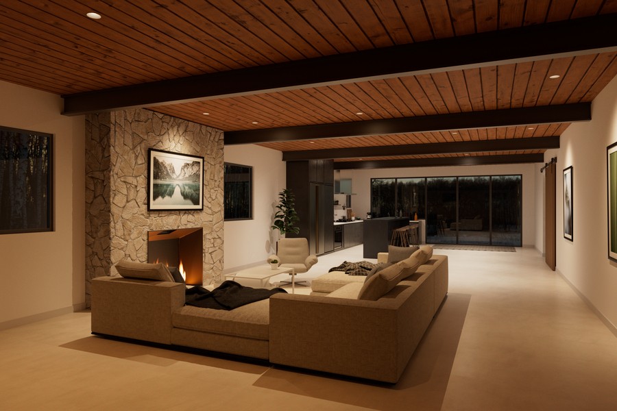 A modern living space with a stone fireplace, wooden ceiling, and recessed DMF Lighting. 