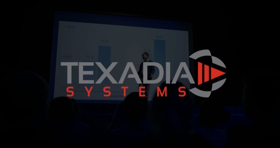 Text that reads ‘Texadia Systems’ laid over an image of a person presenting on a projector screen. 