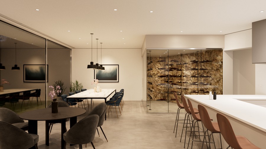 A modern home with a dining counter, dining table, glass-walled wine cellar, and small aperture recessed lighting. 