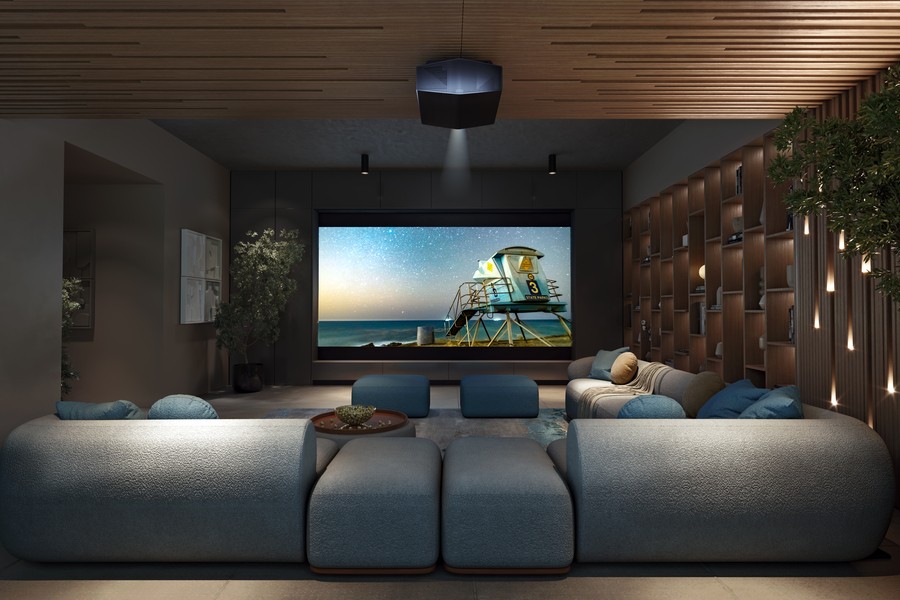 A modern home theater with a Sony projector on the ceiling and projector screen.