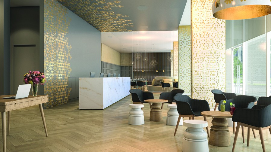 A modern hotel lobby with seating and a reception desk. 