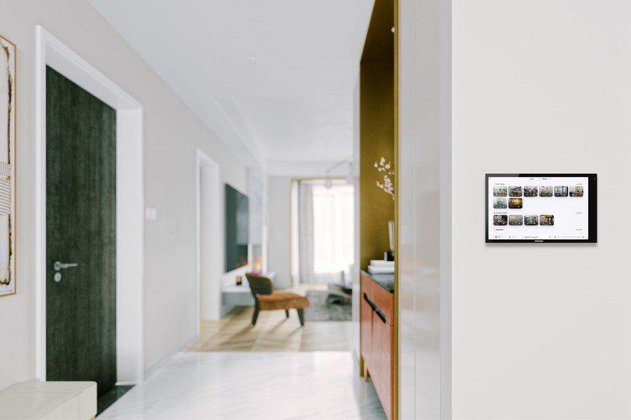 A home interior with a Control4 smart home control panel on the wall. 