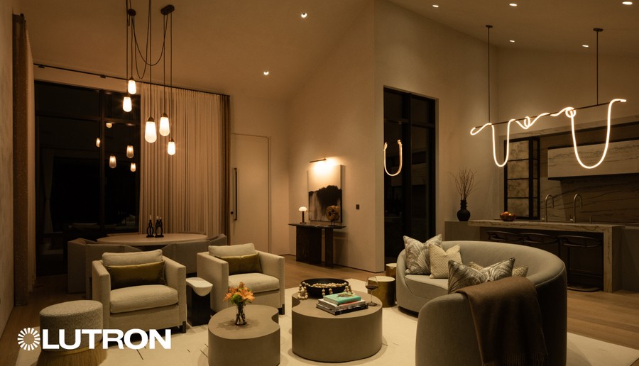 A luxurious living room with warm-toned Lutron lighting. 