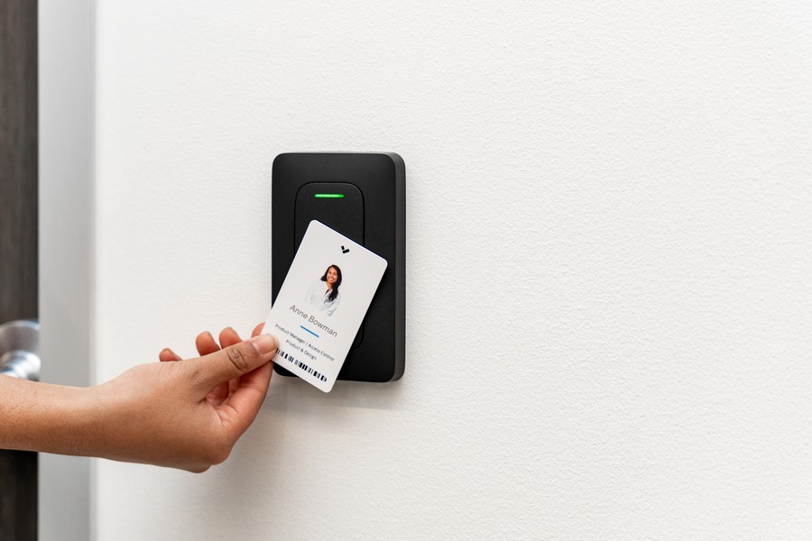 Hand tapping an ID card to a Verkada access control reader.